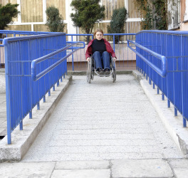 women in wheelchair leaving a building