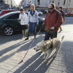 a blind person walking in the street