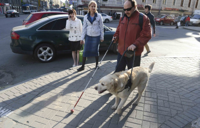 a blind person walking in the street