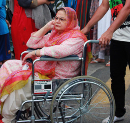 Pakistani woman in wheelchair during a rally