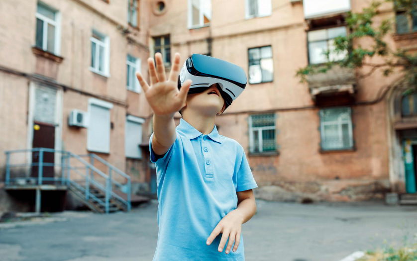 little boy using vr virtual reality goggles