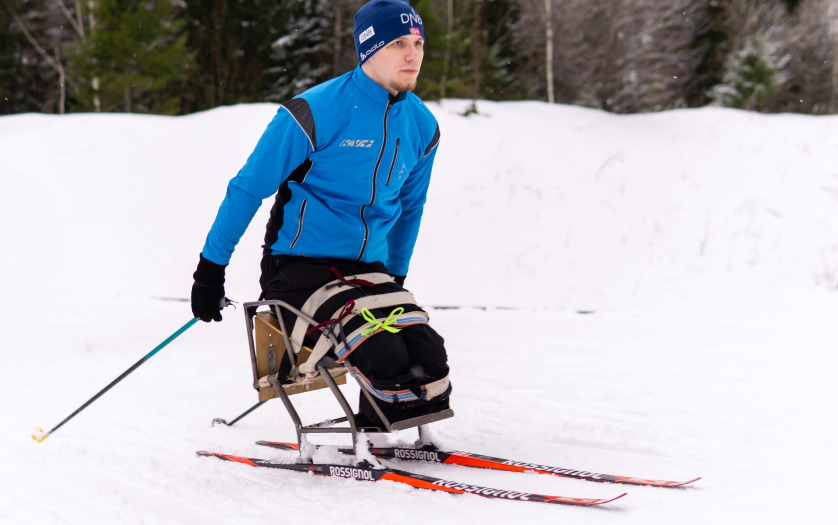 athlete skier with disability training outdoors in winter