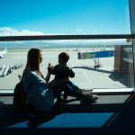 Little boy and his mother sitting in an airport