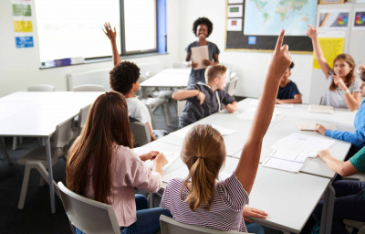 High School Students Raising Hands To Answer Question