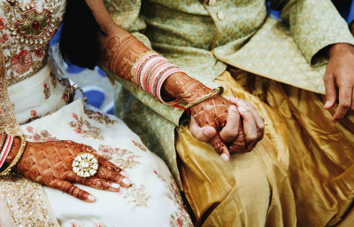 Indian wedding couple are holding hands
