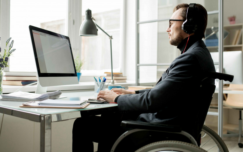 man in wheelchair working in the office