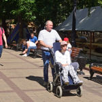 person pushing a man in wheelchair