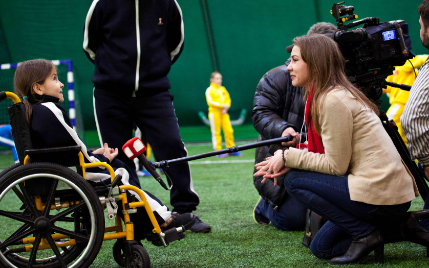 a journalist taking interview of girl in wheelchair