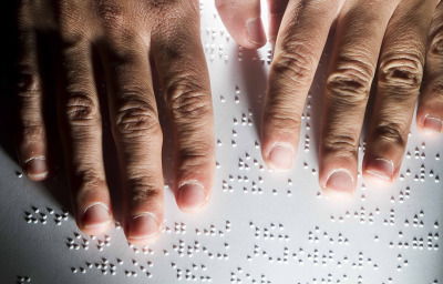 blind person reading braille