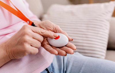 Senior woman hand pressing Alarm Button, closeup