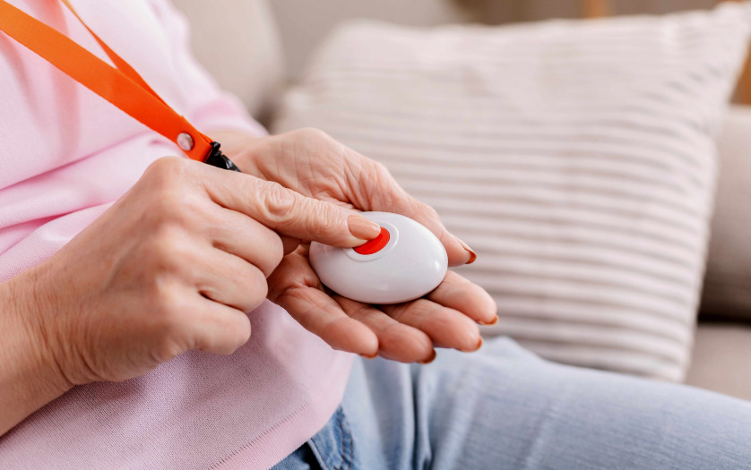 Senior woman hand pressing Alarm Button, closeup