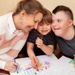 Happy woman with children with down syndrome