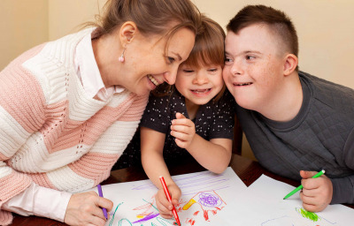 Happy woman with children with down syndrome