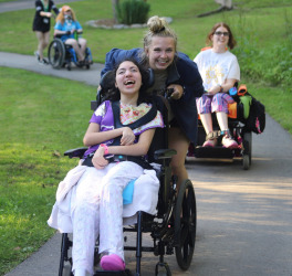 smiling girl in wheelchair with friend