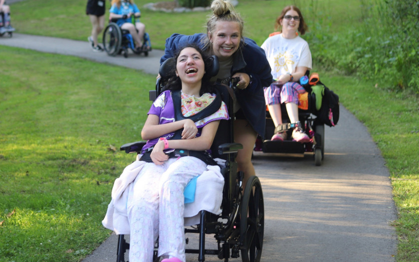 smiling girl in wheelchair with friend