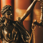Blindfolded justice holding up the scales