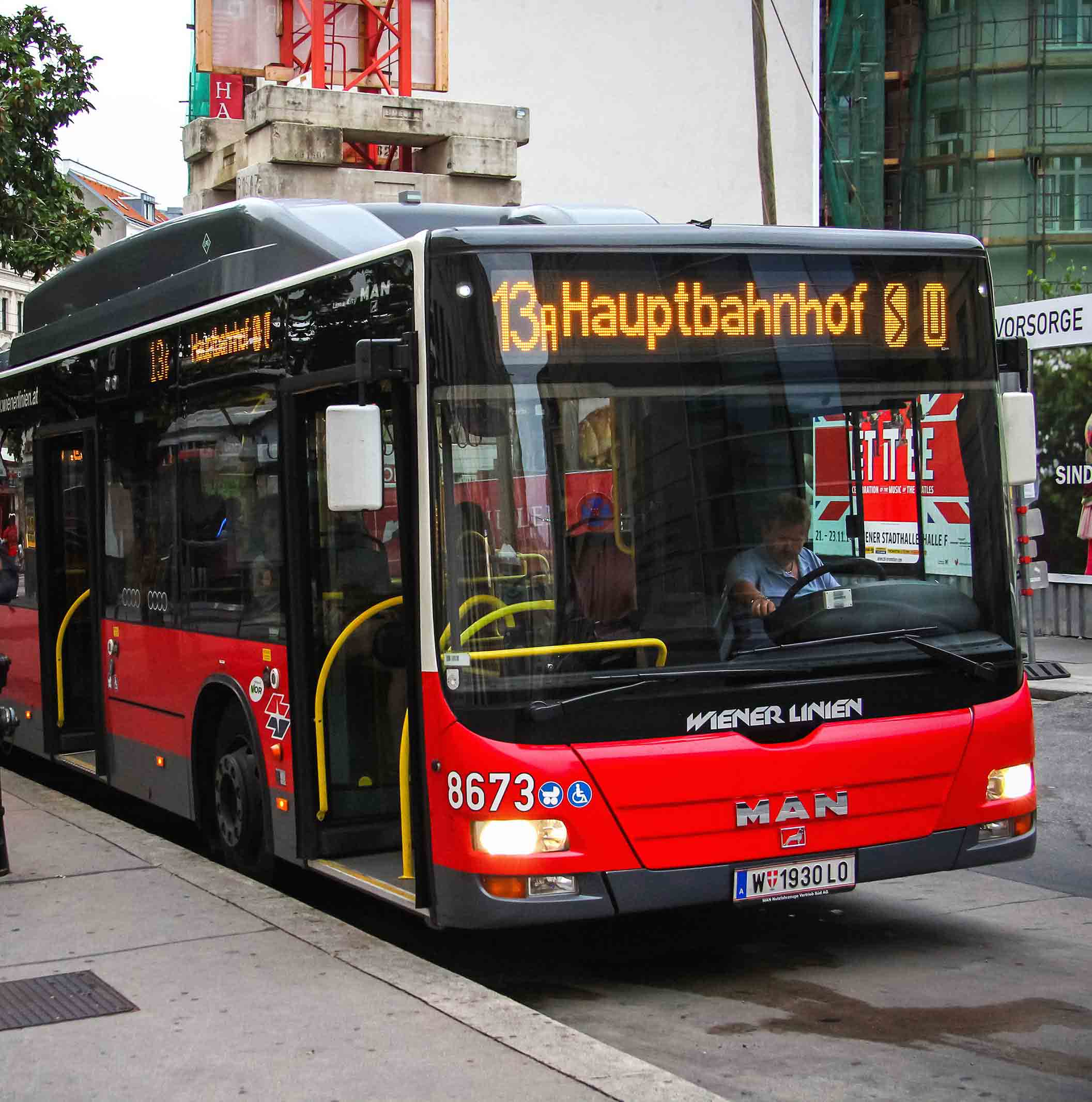 Red urban buses MAN A21 Lion's City LPG in the city street