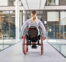 woman in a wheelchair on the move in the building