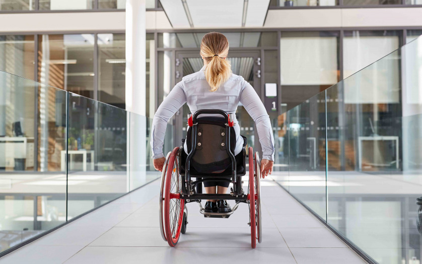 woman in a wheelchair on the move in the building