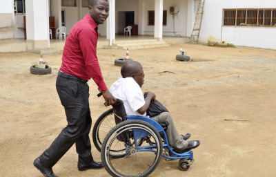 a man pushing a person in wheelchair