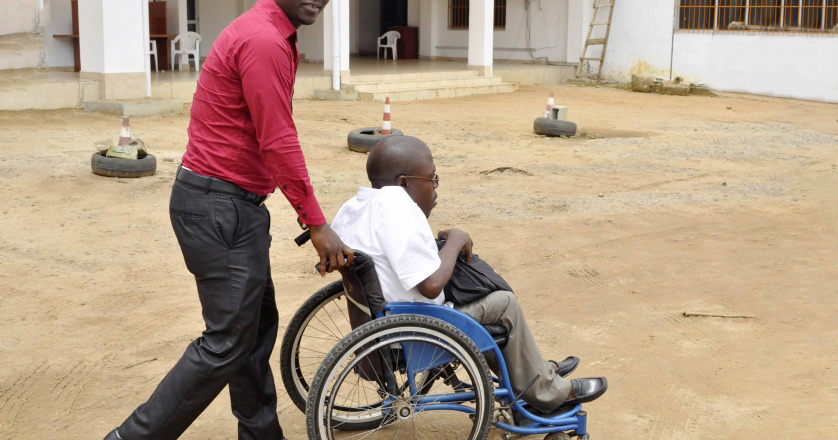a man pushing a person in wheelchair