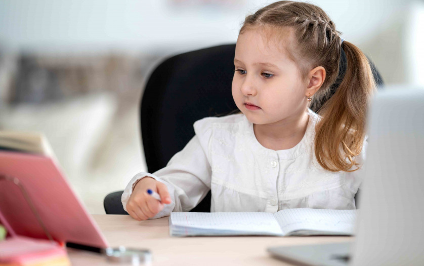 girl, doing homework, writing in notebook, using laptop
