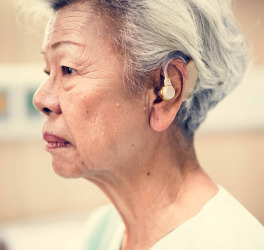 An elderly woman with hearing aid