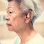 An elderly woman with hearing aid