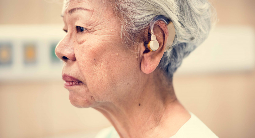 An elderly woman with hearing aid