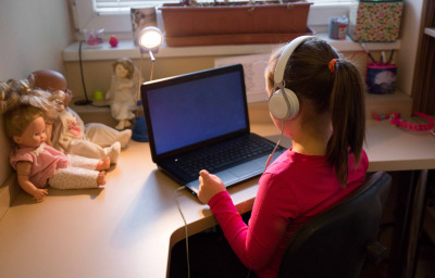 Girl in headphones using laptop