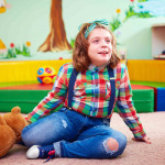kid with disability playing in kindergarten