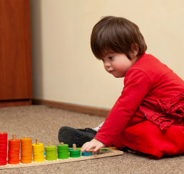 Side view of child with down syndrome playing