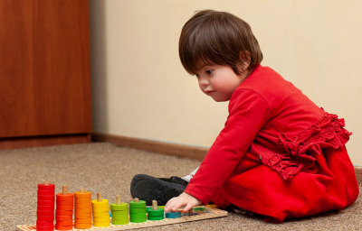 Side view of child with down syndrome playing