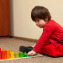 Side view of child with down syndrome playing