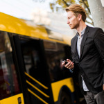 man using mobile to track bus