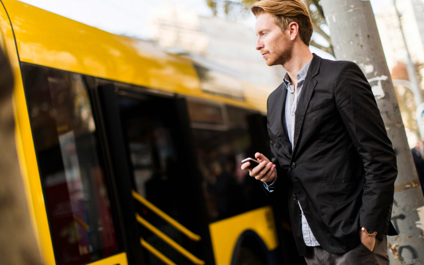 man using mobile to track bus
