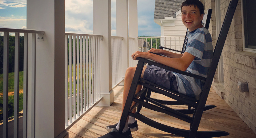 a teenage with autism relaxing with rocking chair