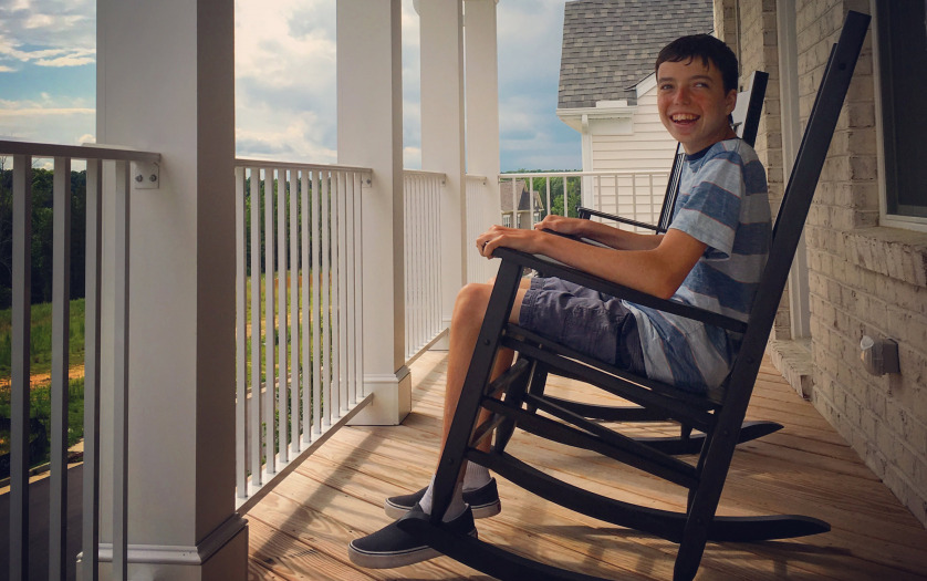 a teenage with autism relaxing with rocking chair