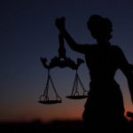 Statue of the goddess Themis against the sky at sunset