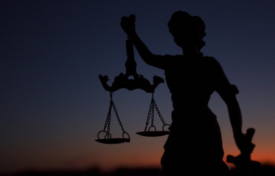 Statue of the goddess Themis against the sky at sunset