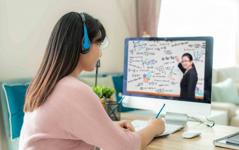 Asian woman student video conference e-learning with teacher on computer in living room at home