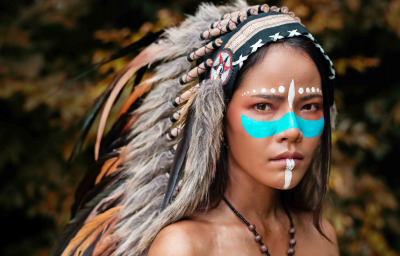Beautiful woman wearing headdress feathers