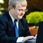Close up portrait of businessman with down syndrome working