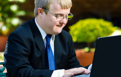 Close up portrait of businessman with down syndrome working