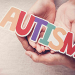 Hands holding autism word