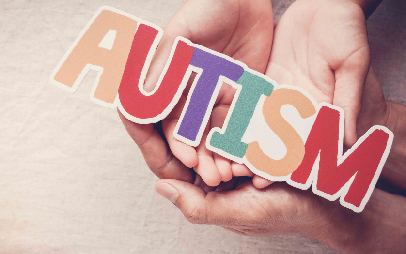 Hands holding autism word