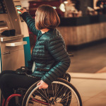 woman in wheelchair using ATM