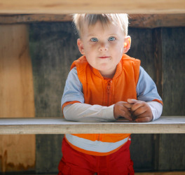 boy with autism under table
