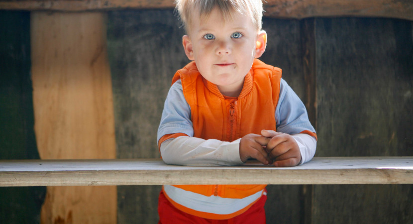 boy with autism under table