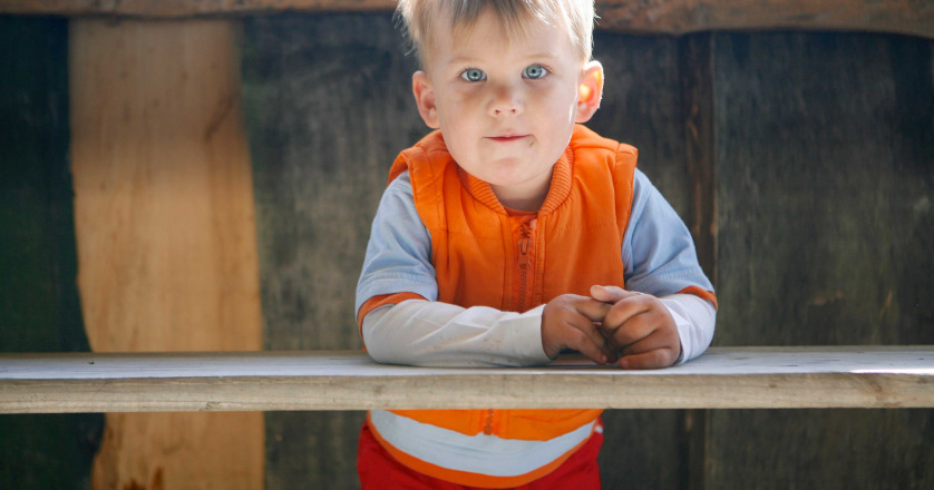 boy with autism under table